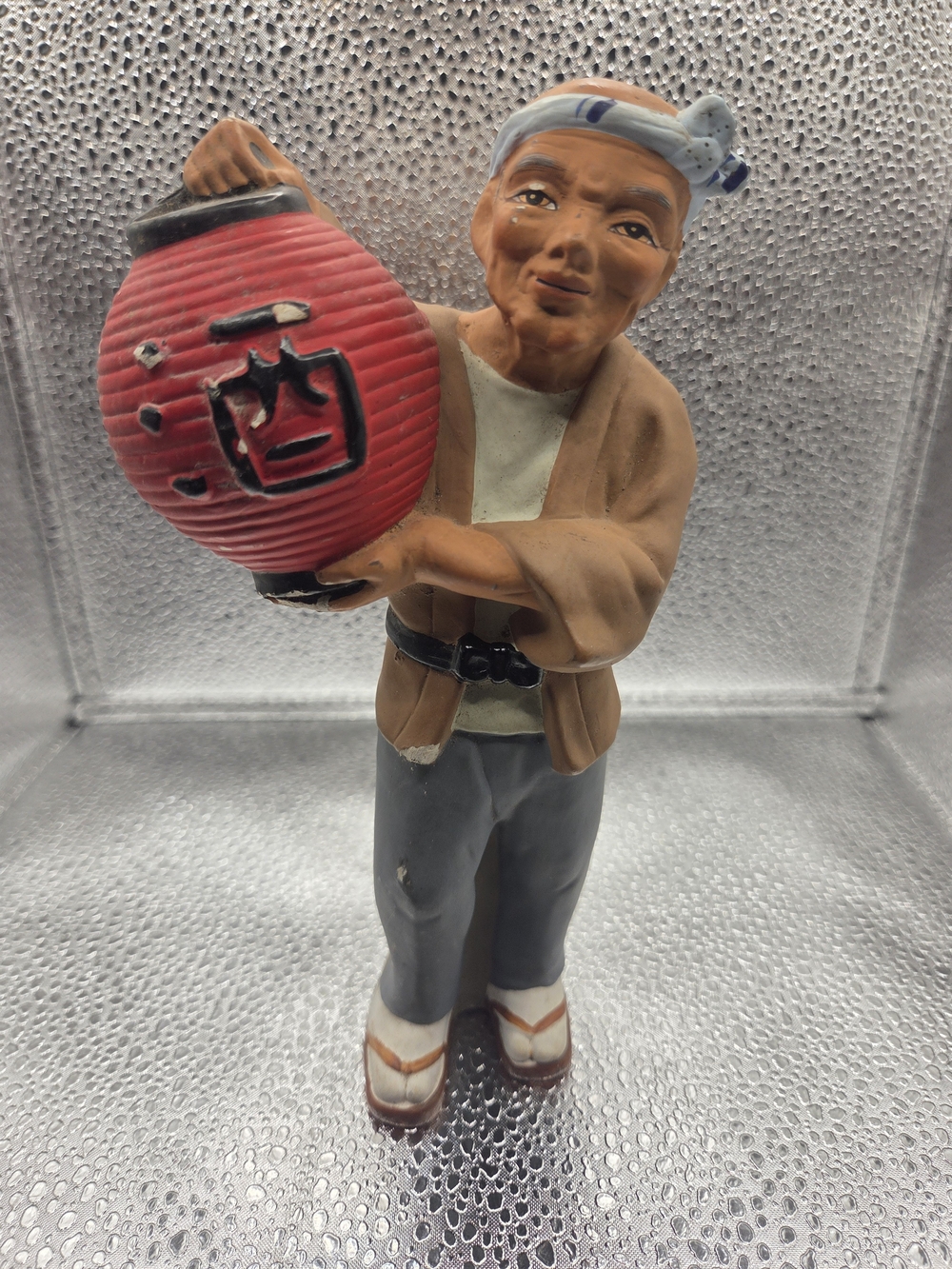 Vintage Japanese ceramic figurine depicting a man with Lantern